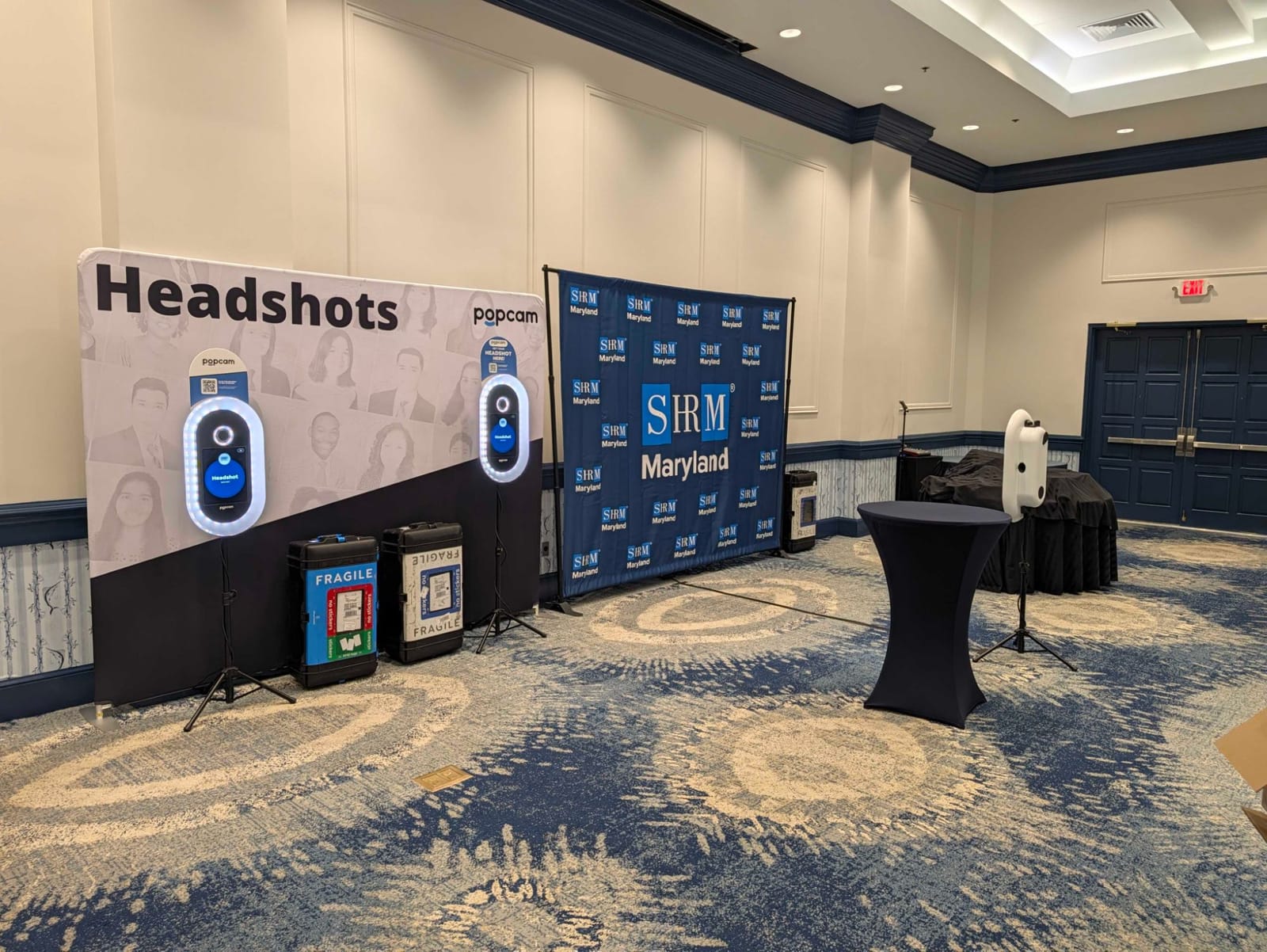 Two Popcam headshot kiosks beside an SHRM Maryland step-and-repeat backdrop